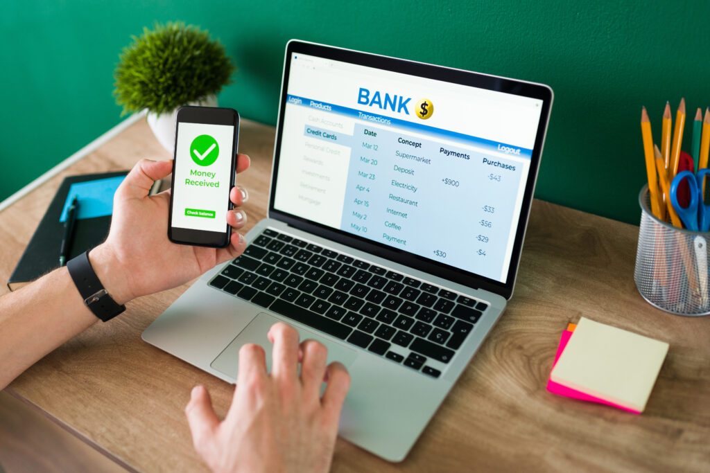 wire-transfer-young-man-using-his-smartphone-laptop-banking-transaction-some-payments-1024x683 An Ultimate Guide To Business Banking Account Online In The Future (2025)