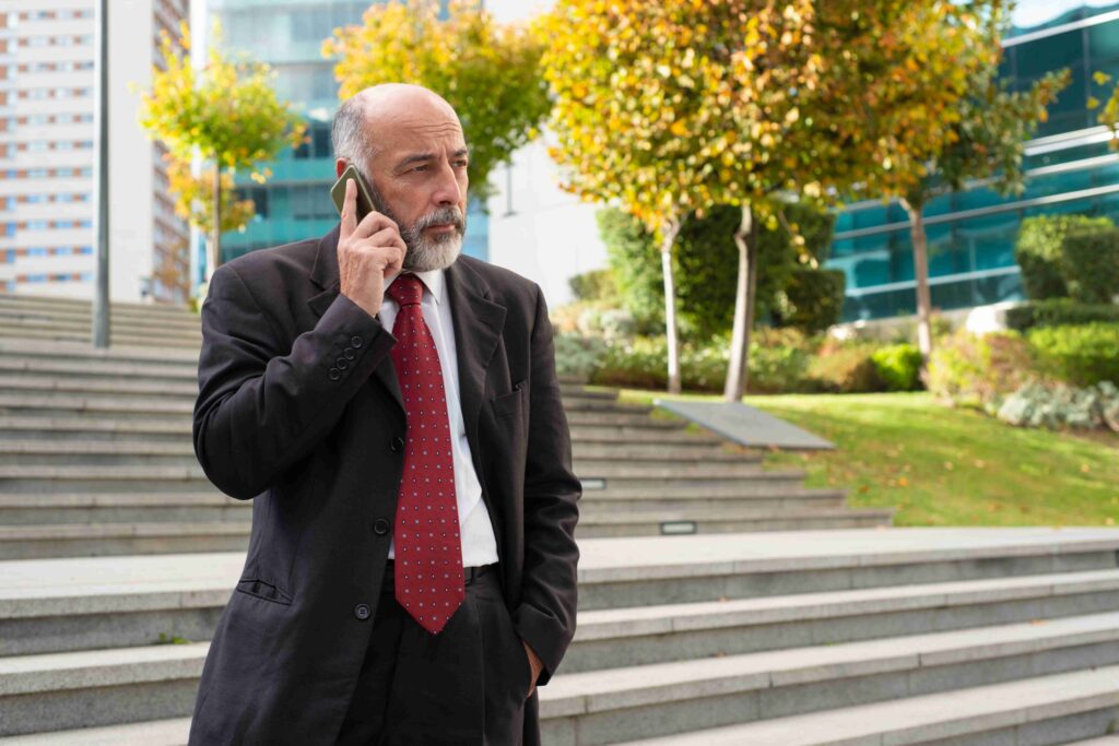businessman-talking-by-smartphone-looking-away_11zon-1024x683 Nathaniel Mandrell Dudney: Rising Beyond Fame & Legacy (2025)